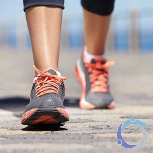 A pair of running shoes in action show that there are many benefits of walking.