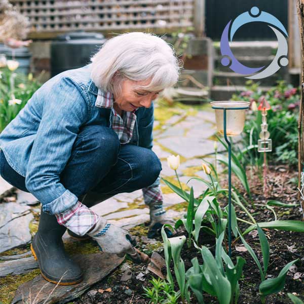 Outdoor activities for elderly parents, like this older gardening, break up the monotony of daily routines and give everyone a chance to enjoy the changing seasons together.