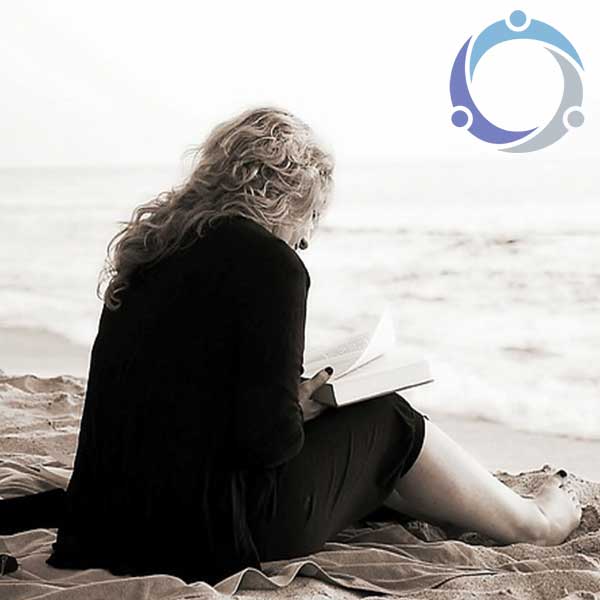 This caregiver is finally taking time for herself to read a book on the beach so she can relieve her anxiety and stress.