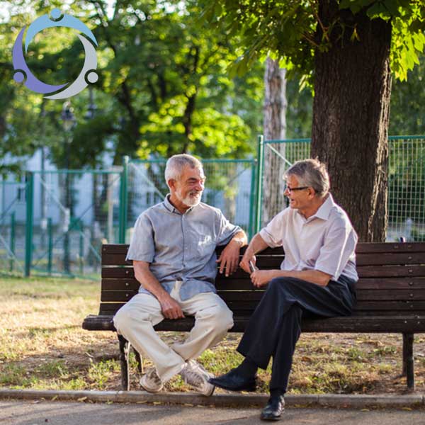 Two men ask for help from each other while sitting on a park bench.