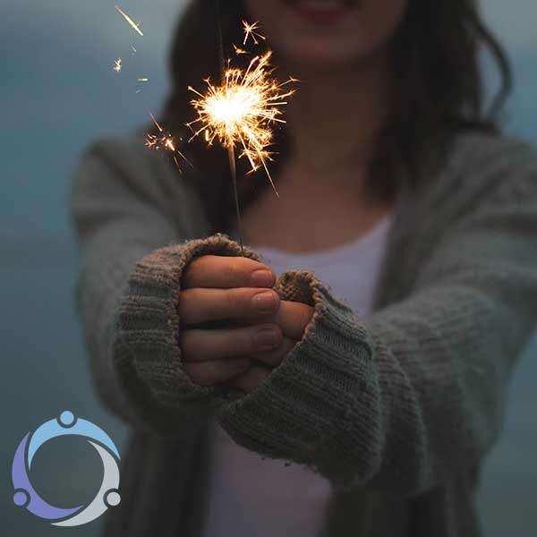 As a girl offers a sparkler, she represents how to volunteer for someone without the support of a community.
