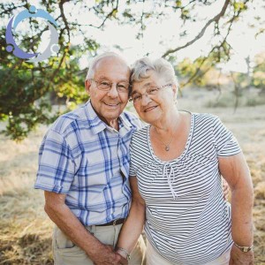 An older couple poses together while overcoming the challenges of family caregiving.