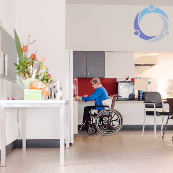 A woman is in a wheelchair accessible kitchen which makes her life so much easier.