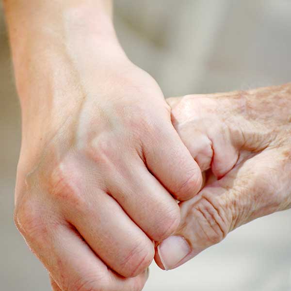 As a young hand holds an older one, Lotsa Helping Hands provides guidance about elderly care.