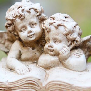 Choosing a grave stone, like this one with cherubs, is just part of learning how to plan a funeral.